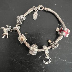 Girls Pandora sterling silver bracelet with 7 charms. $250